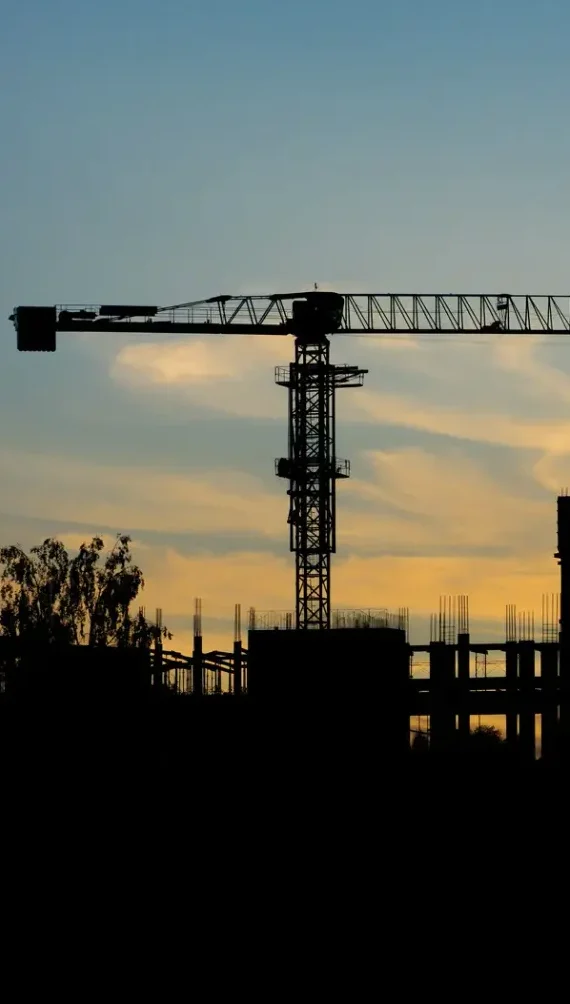 Construction crane at sunset